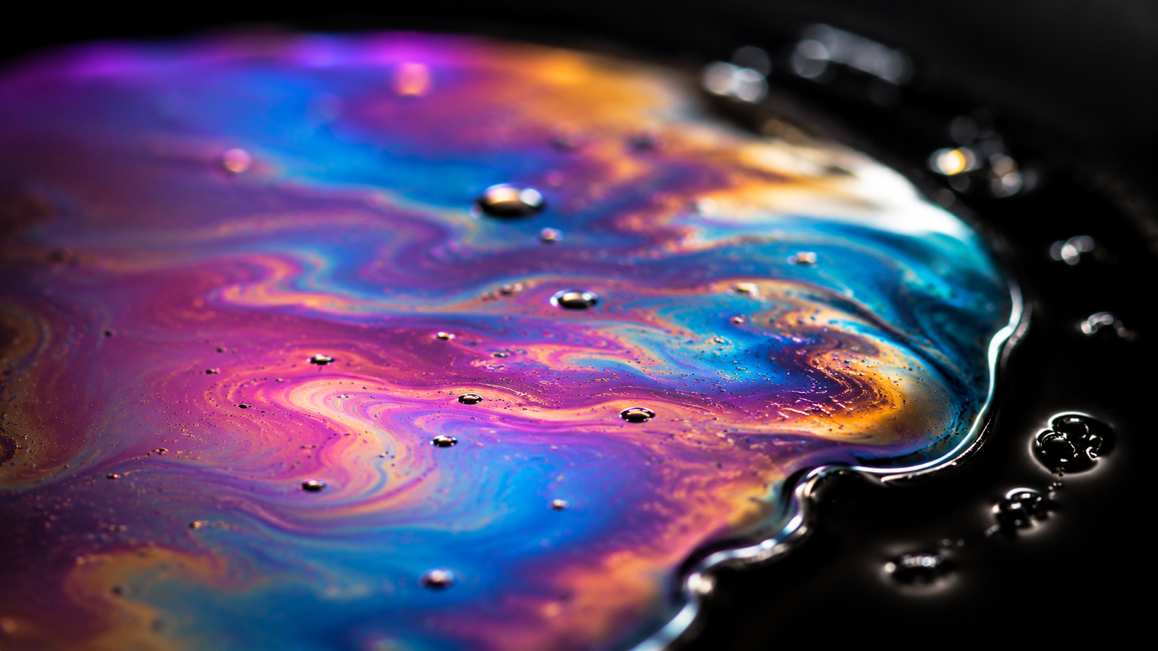 Iridescent oil-on-water macro, natural pink, violet, cyan and gold rainbow gradient